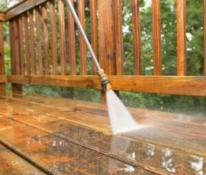 Spraying down a wooden deck with water